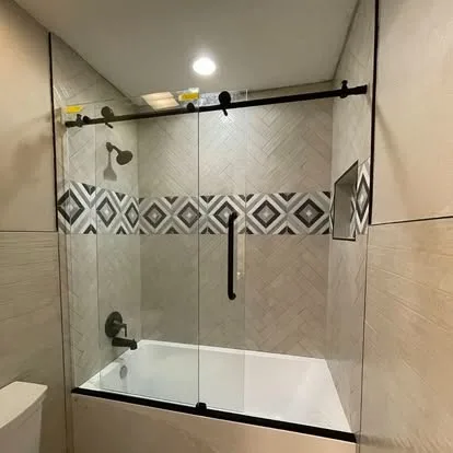 Finished tiled walk-in shower with a frameless glass enclosure on a Hildebrand bathroom remodel
