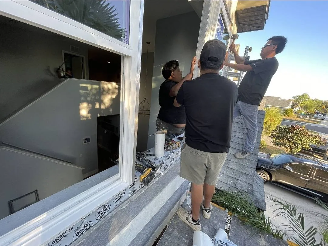 Hildebrand's licensed crew installing impact windows on a two-story Florida home