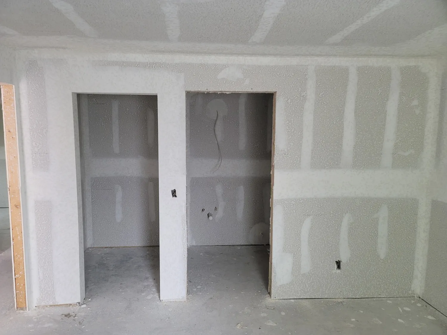 Drywall finishing stage with seams mudded and ready for sanding