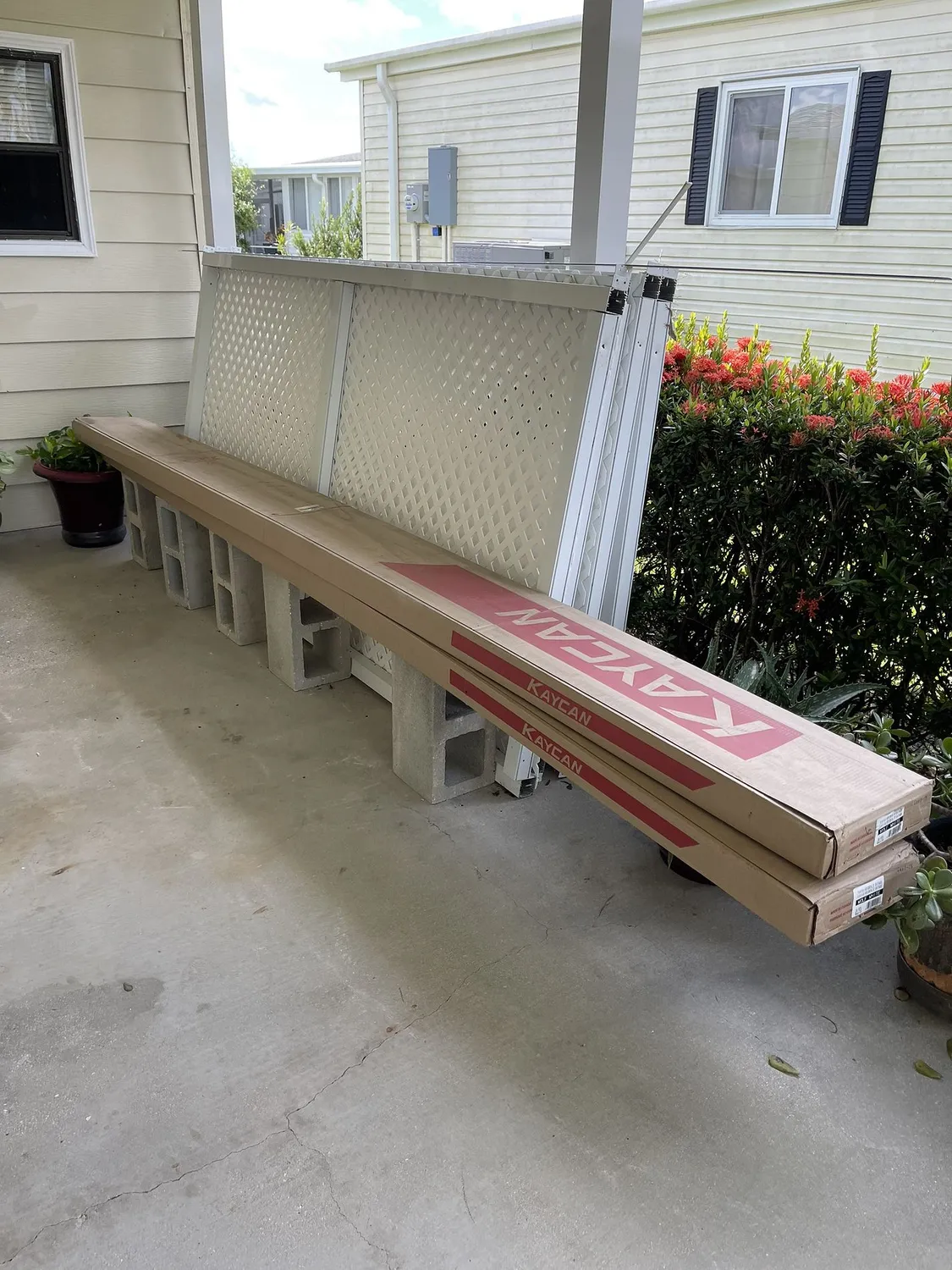 Siding materials staged and organized on site at the start of an exterior project